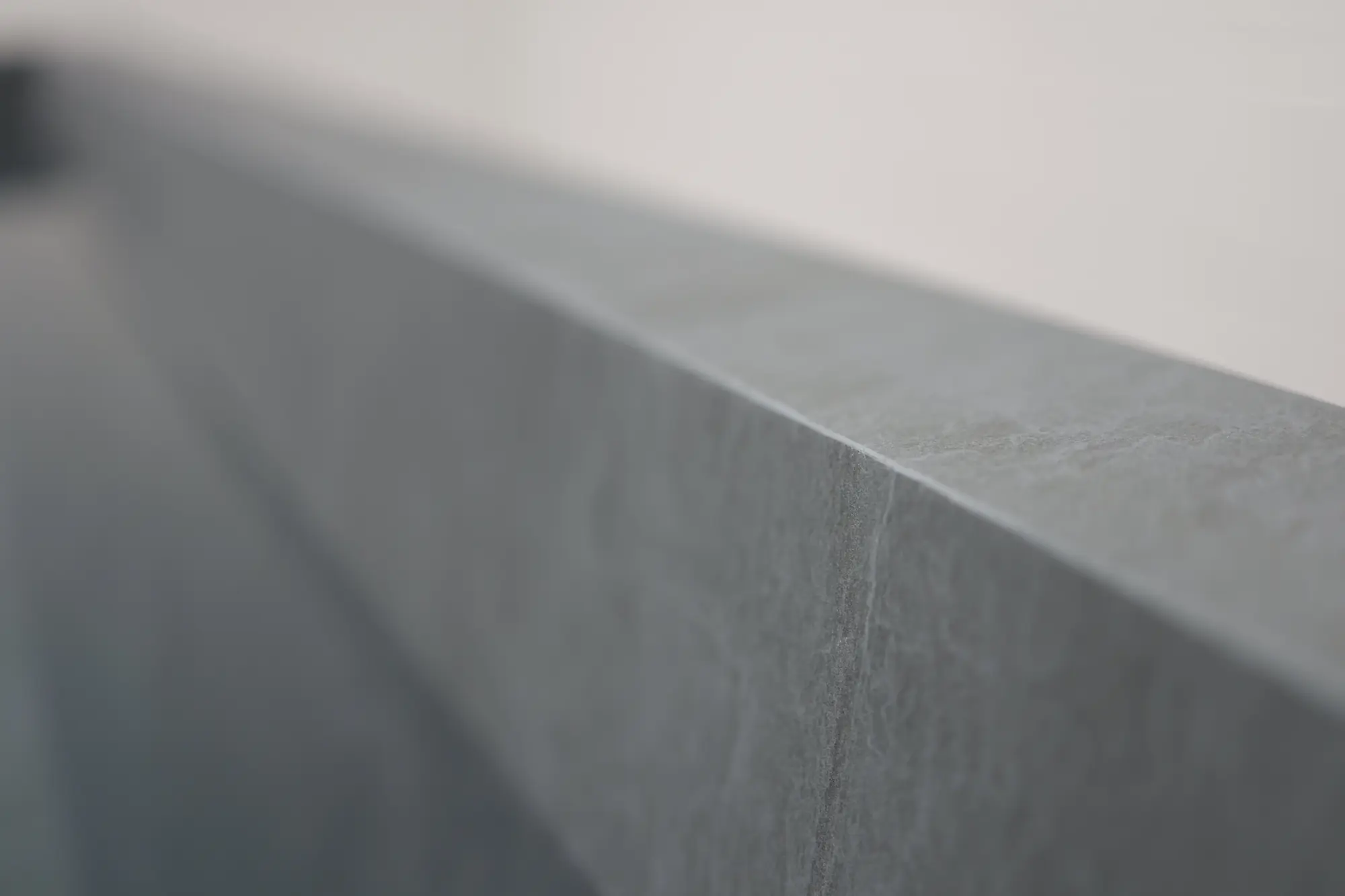 Close detail of the mitred stone edge on a Nordic Vitality basin