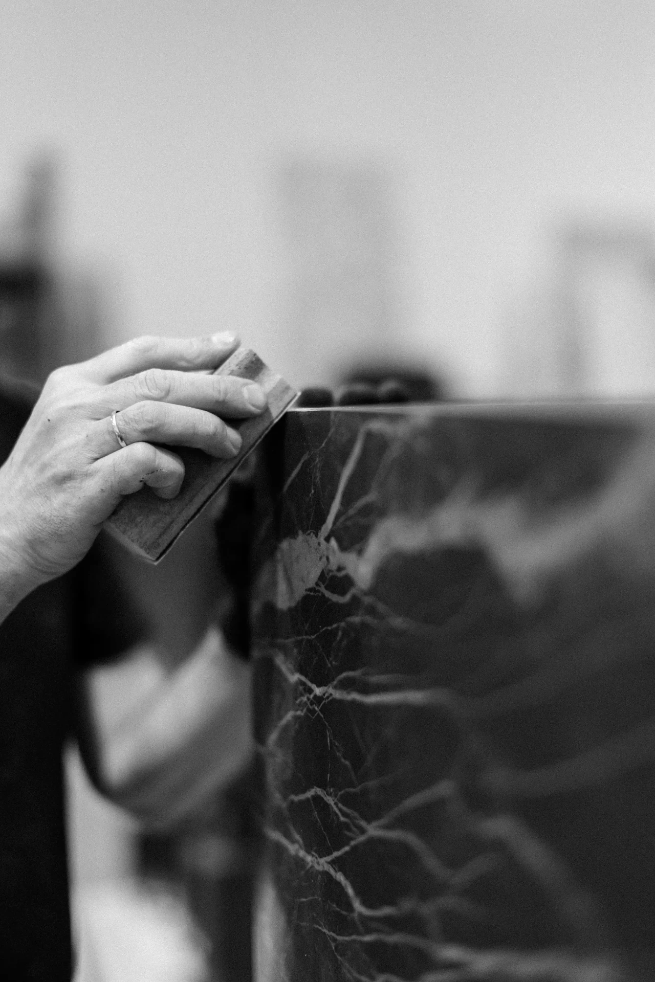 Hand-polishing the edge of a Nordic Vitality basin, stone detail