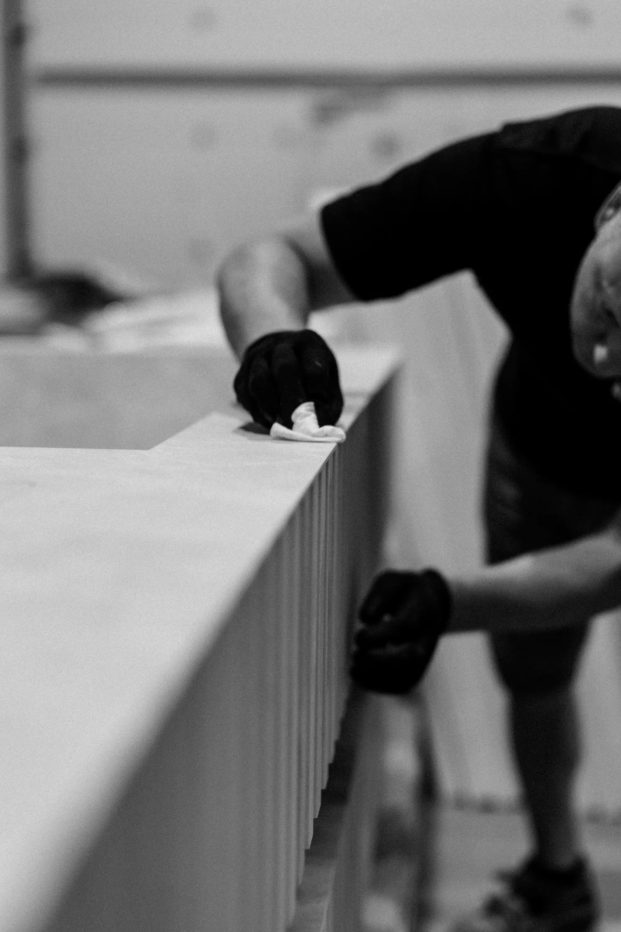 Craftsman finishing the rim of a cold plunge shell in the workshop